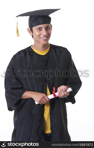 Portrait of happy graduate student holding diploma over white background