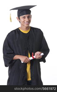 Portrait of happy graduate student holding diploma over white background