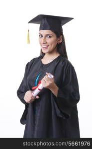 Portrait of happy graduate student holding diploma over white background