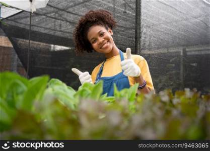 Portrait of happy half Thai half African woman farmer standing behind vegetable plot in her backyard. Concept of agriculture organic for health, Vegan food and Small business.