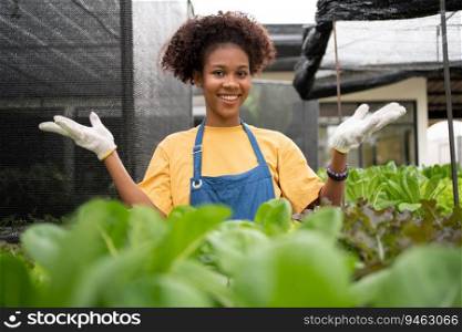 Portrait of happy half Thai half African woman farmer standing behind vegetable plot in her backyard. Concept of agriculture organic for health, Vegan food and Small business.