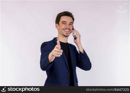 Portrait of happy handsome businessman talking by mobile phone and pointing finger at camera isolated over white background.
