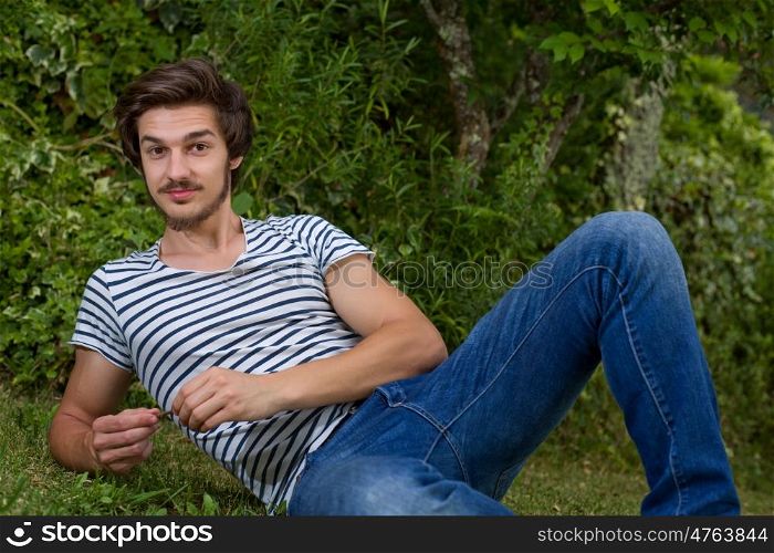 portrait of happy handsome young man, summer outdoors.
