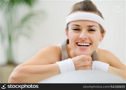 Portrait of happy healthy woman on fitness ball