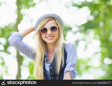 Portrait of happy hipster girl in the park
