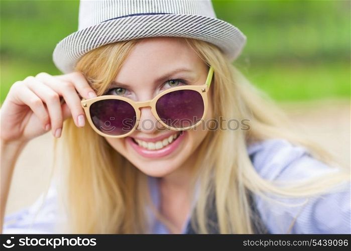 Portrait of happy hipster girl wearing sunglasses