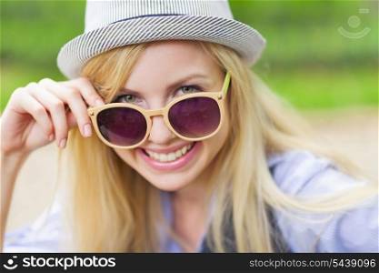 Portrait of happy hipster girl wearing sunglasses