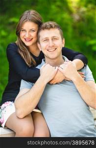 Portrait of happy hugging couple posing at summer park