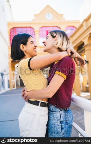 Portrait of happy lesbian couple spending time together and hugging at the street. LGBT., love and relationship concept.