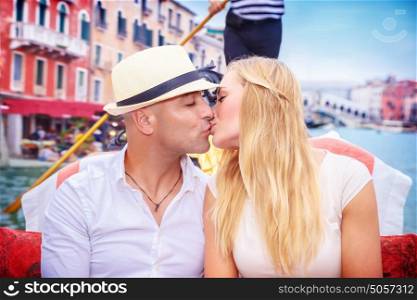Portrait of happy loving couple in romantic honeymoon, kissing on a gondola, vacation in Italy, enjoying holidays in Europe