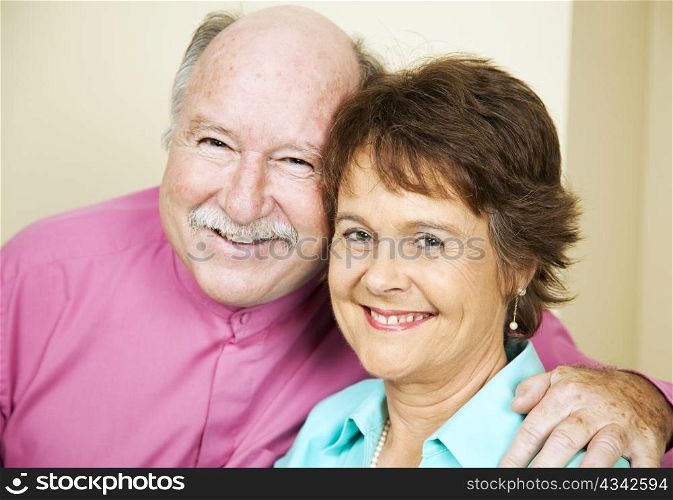 Portrait of happy, loving couple in their late fifties.