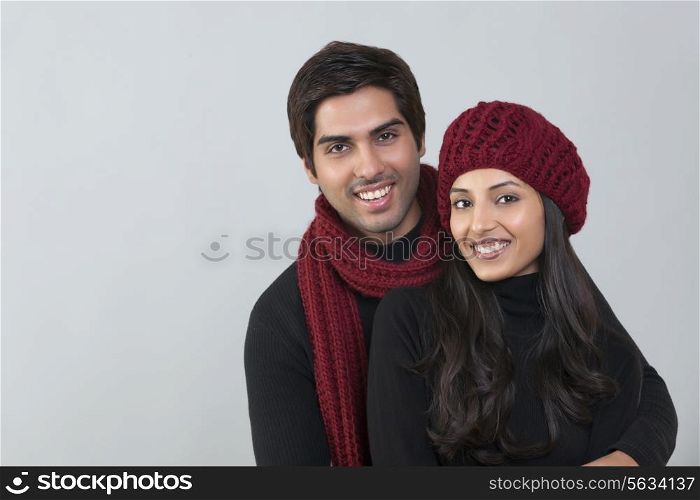 Portrait of happy loving couple over grey background