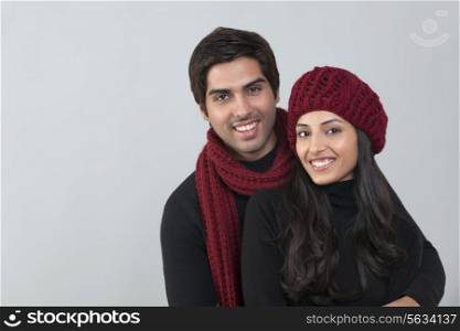 Portrait of happy loving couple over grey background