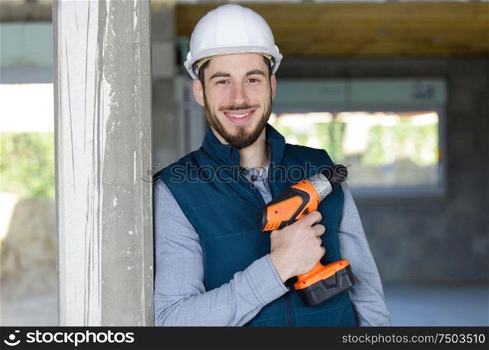 portrait of happy man holding his drill