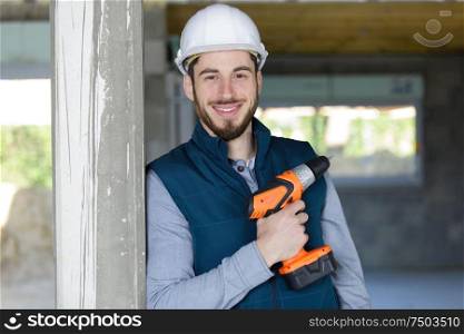 portrait of happy man holding his drill