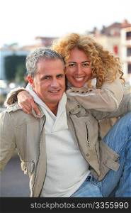 Portrait of happy mature couple in town