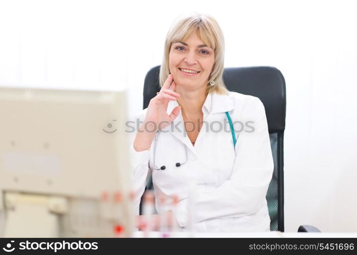 Portrait of happy mature doctor woman at laboratory