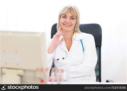 Portrait of happy mature doctor woman at laboratory