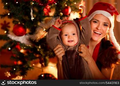 Portrait of happy mother and adorable baby in suit of Santa&rsquo;s little helper&#xA;