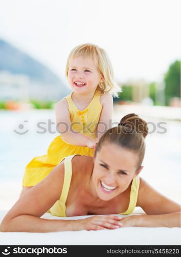 Portrait of happy mother and baby at poolside