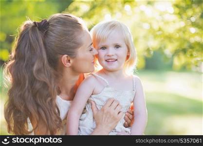 Portrait of happy mother and baby outdoors