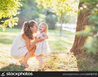 Portrait of happy mother and baby playing outdoors