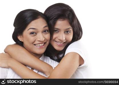 Portrait of happy mother and daughter embracing