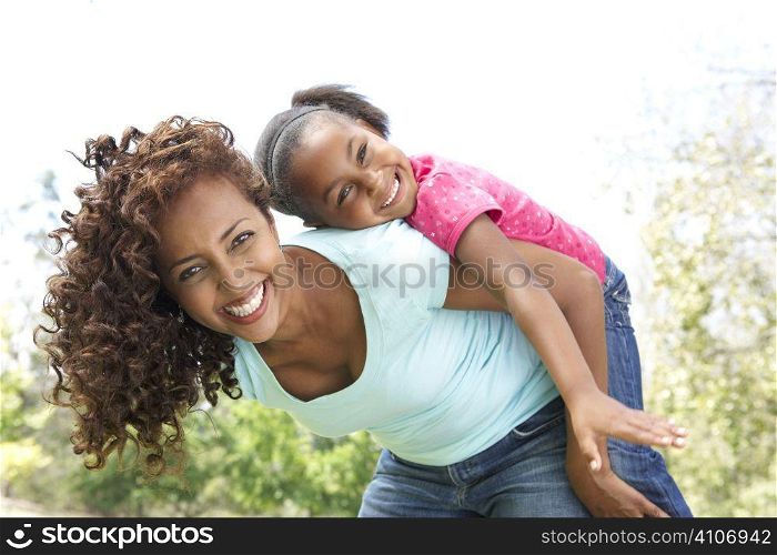 Portrait of Happy Mother and Daughter In Park