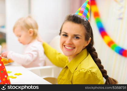 Portrait of happy mother celebrating baby first birthday