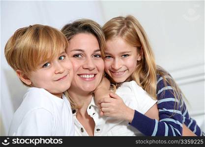 portrait of happy mother with 2 blond children