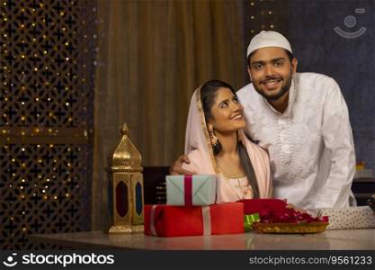 Portrait of happy Muslim couple together at home