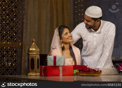 Portrait of happy Muslim couple together at home