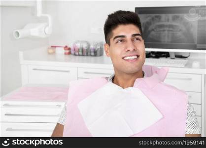 Portrait of happy patient in dental chair. High quality photo. Portrait of happy patient in dental chair.