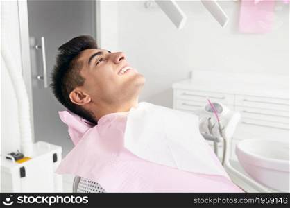 Portrait of happy patient in dental chair. High quality photo. Portrait of happy patient in dental chair.