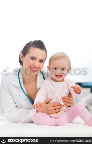 Portrait of happy pediatric doctor and baby