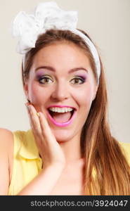 Portrait of happy pretty pin up girl with bow.. Portrait of happy smiling pretty pin up girl with hairband bow. Attractive gorgeous young retro woman posing in studio.