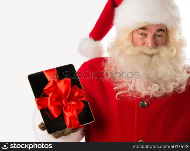 Portrait of happy Santa Claus holding gift Tablet computer in his hands with ribbon and looking at camera