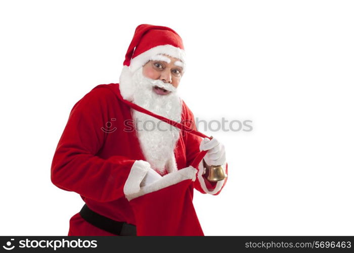 Portrait of happy Santa removing something from bag over white background