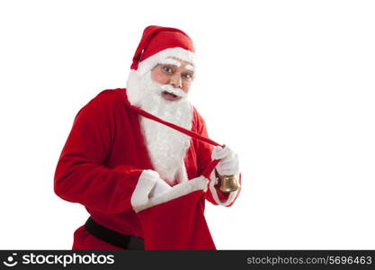 Portrait of happy Santa removing something from bag over white background