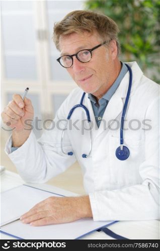 portrait of happy senior caucasian doctor in glasses