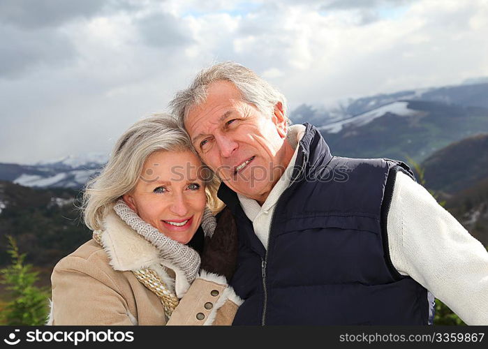 Portrait of happy senior couple at the mountain