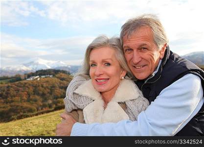 Portrait of happy senior couple in countryside