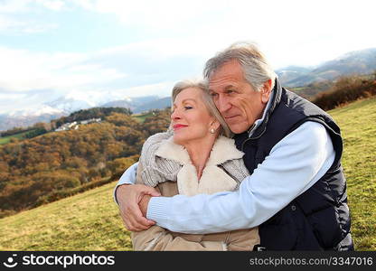 Portrait of happy senior couple in countryside