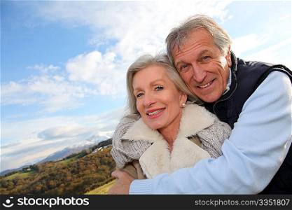 Portrait of happy senior couple in countryside