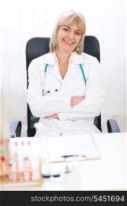 Portrait of happy senior doctor woman at office