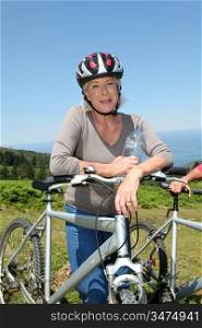Portrait of happy senior woman on mountain bike