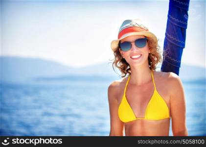 Portrait of happy sexy girl enjoying sea cruise, relaxation outdoors on the yacht, luxury summertime vacation, pleasure and enjoyment concept