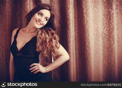 Portrait of happy sexy gorgeous woman by curtain. Attractive sensual young girl with long hair in lingerie. Female fashion.. Portrait of happy sensual young woman in lingerie.