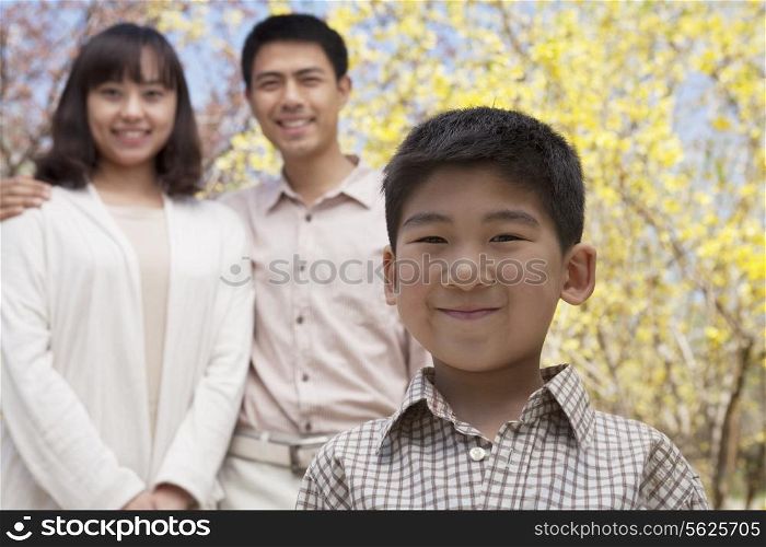 Portrait of happy smiling family in the park in springtime, Beijing, China