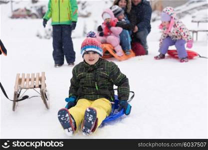 portrait of happy smiling little boy child outdoors having fun and playing on snowy winter day
